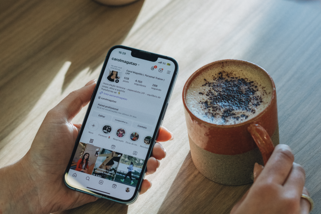 Person browsing Instagram over coffee, relaxed morning vibe.