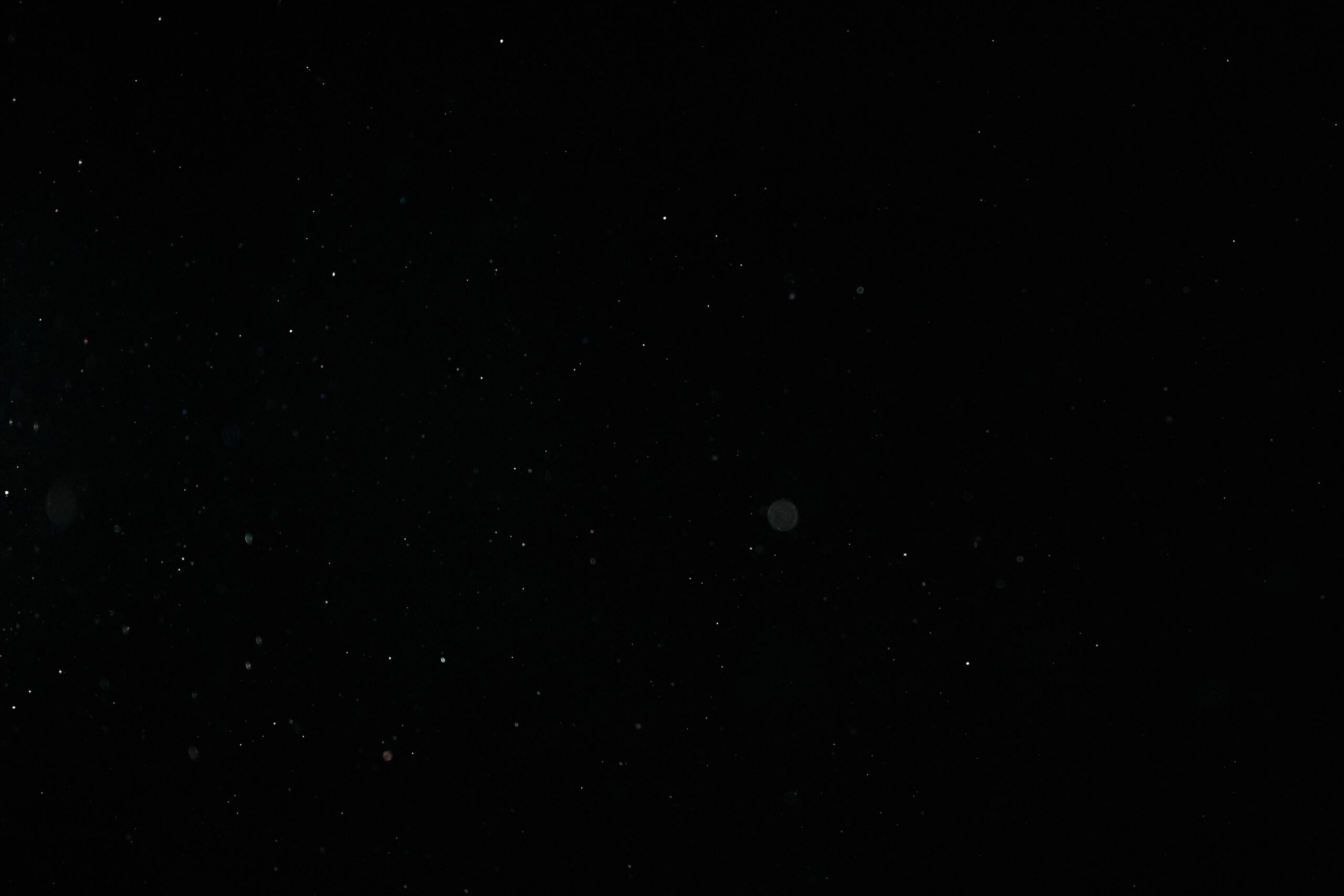 Creative abstract image of particles on a black background resembling a starry night sky.